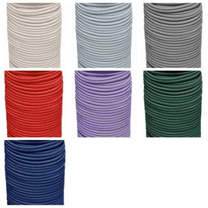 May include: A collection of seven spools of elastic cord in various solid colors including white, light blue, gray, red, purple, dark green, and navy blue. Each spool features a tightly wound, smooth, cylindrical cord with a consistent texture.