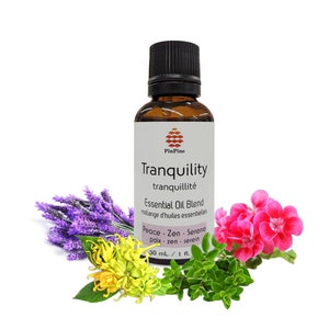 May include: A brown glass bottle with a white label that reads "Tranquility tranquillité Essential Oil Blend mélange d'huiles essentielles Peace. Zen. Serene paix. zen. serein 30 ml / 1 fl."