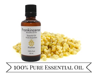 May include: A brown glass bottle with a label that reads "Frankincense Boswellia Serrata Essential Oil Huile Essentielle PinPine 100% Pure 50 mL". The bottle is sitting on a white surface next to a pile of yellow frankincense resin. The text "100% PURE ESSENTIAL OIL" is written on a white banner.
