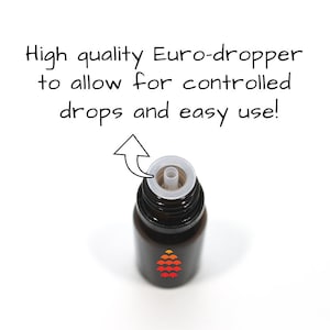 May include: Close-up of a dark brown glass bottle with a white euro-dropper. The bottle has a red and orange logo of a stylized pine cone.
