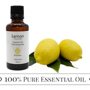 May include: A 50 ml amber glass bottle of 100% pure lemon essential oil with a white label that reads "Lemon Citrus limon Essential Oil Huile Essentielle PinPine 100% Pure 50 ml". Two whole lemons are in the background.