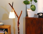 A wooden floor lamp with a cream shade, a wooden lamp, a romantic floor lamp, a branch floor