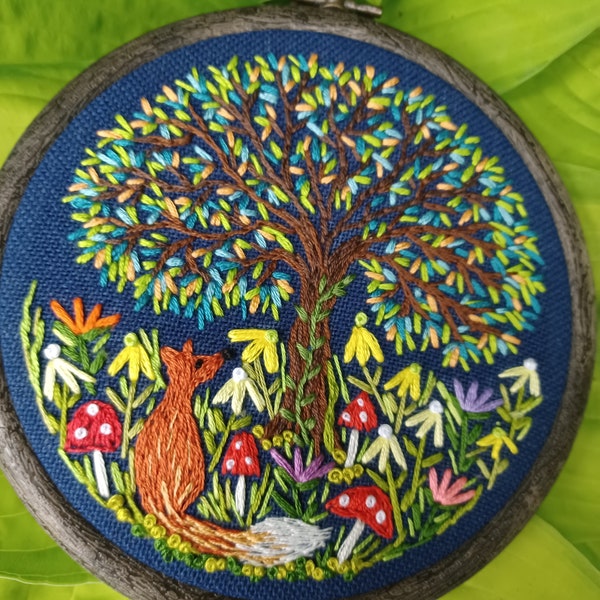 Fox and Flower's. A delightful handstitched embroidery sitting under a colourful a magical tree surrounded by flowers and mushrooms.