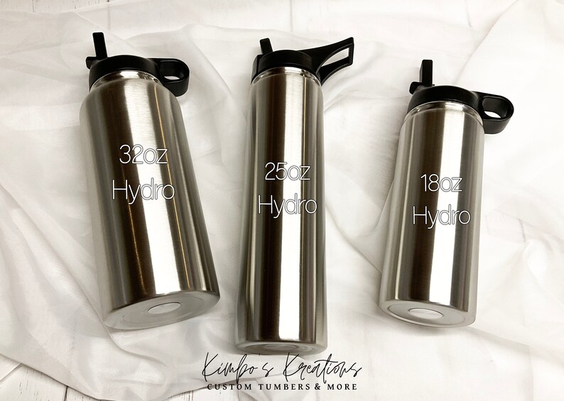 Peut inclure: Trois bouteilles d'eau en acier inoxydable avec des couvercles et des poign&eacute;es noirs. Les bouteilles sont &eacute;tiquet&eacute;es avec le texte "32oz Hydro", "25oz Hydro" et "18oz Hydro".