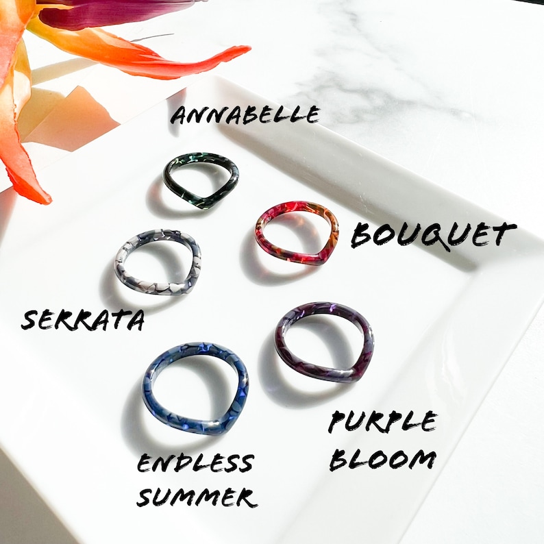 May include: Five colorful resin rings with different patterns and names: Annabelle, Bouquet, Serrata, Endless Summer, and Purple Bloom.