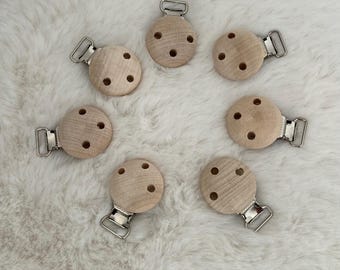 May include: Seven wooden baby teethers with silver clips. Each teether has four holes.