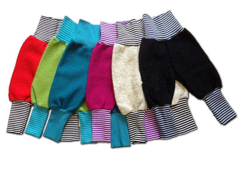 May include: A set of eight colorful fleece pants with striped cuffs. The pants are made of a soft, comfortable fabric and have a relaxed fit.