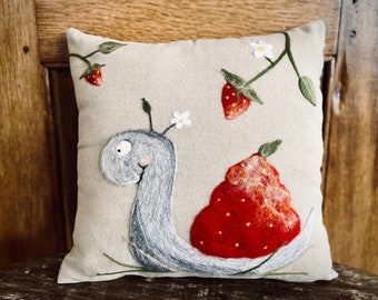 Hand-felted cushion with strawberry snail - art pleasure