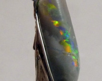 May include: A silver pendant with a gray opal stone. The opal has iridescent flashes of green, blue, and orange.