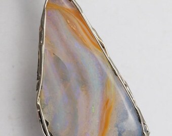 May include: A silver pendant with a large, iridescent opal stone. The opal has a mix of blue, white, and orange colors.