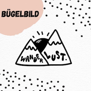 May include: Black and white iron-on transfer design featuring two mountains with a sun rising behind them. The text "Wanderlust" is written on the mountains.