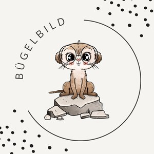 May include: A cartoon meerkat wearing glasses sits on a rock, inside a black circular frame. The meerkat is brown with a white face and pink cheeks. The text "BÜGELBILD" is curved around the top left of the circle. Black dots are scattered around the circle.