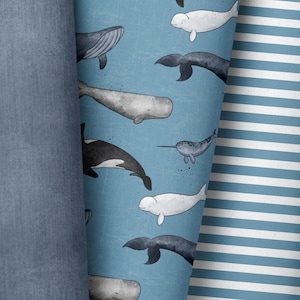 Peut inclure: Un tissu bleu avec un tissu rayé blanc et bleu sur le côté droit. Le tissu bleu a un motif répétitif de baleines, de narvals et de bélugas.