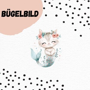 May include: A whimsical illustration of a cat-mermaid hybrid with a floral crown and a teal tail. The image has the text "BÜGELBILD" in bold black letters. The background is white with black polka dots and a pink shape.
