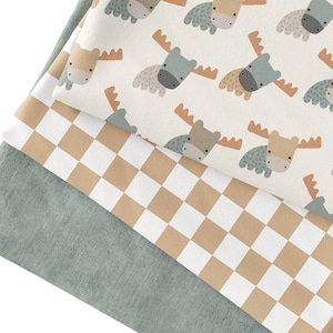 May include: Three fabric swatches, one with a checkered pattern in brown and white, one with a solid light green color, and one with a white background and a repeating pattern of brown and gray moose.