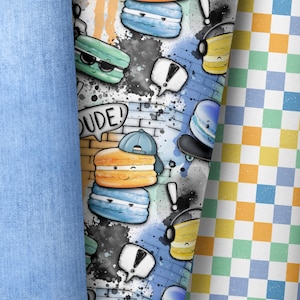 Peut inclure: Un motif coloré composé de macarons bleus, jaunes et verts avec des visages et des lunettes de soleil. Les macarons sont sur un fond blanc avec des éclaboussures de peinture noire et le mot "DUDE!" en lettres noires.