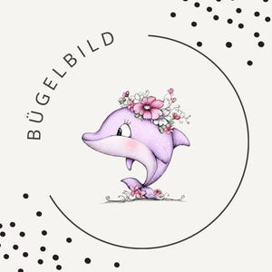 Könnte beinhalten: Eine grafische Illustration eines hellvioletten Delfins, der mit einem Kranz aus rosa und weißen Blumen geschmückt ist und sich in einem dünnen schwarzen Kreisrahmen befindet. Der Text BÜGELBILD steht links, ergänzt durch schwarze Punkte.