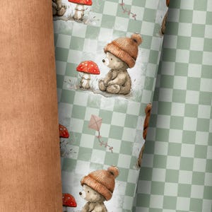 May include: A green and white checkered pattern with a repeating design of a brown teddy bear wearing a brown knit hat and a red mushroom.