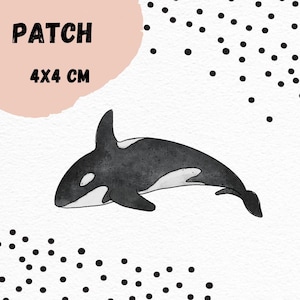 Könnte beinhalten: Schwarz-weiß-Illustration eines Schwertwals, einer Delfinart, auf weißem Hintergrund mit schwarzen Punkten. Das Bild ist mit "PATCH 4X4 CM" beschriftet.