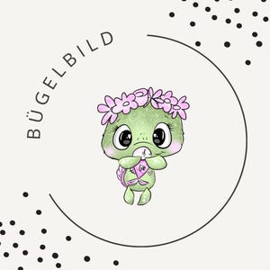 May include: A cartoon illustration of a green turtle wearing a pink flower crown, holding a small pink object with a heart. The turtle is inside a black circle, with the word "BÜGELBILD" in black text. Black dots surround the circle.