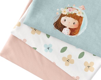 May include: Three fabric swatches with different patterns. The top swatch is light blue with a cartoon girl wearing a flower crown. The middle swatch is white with a repeating pattern of light blue flowers and green leaves. The bottom swatch is light pink.