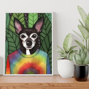 May include: A watercolor illustration of a black and white dog wearing a tie-dye shirt. The dog is surrounded by green leaves.
