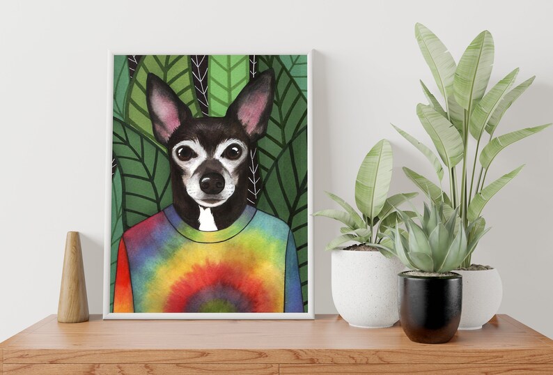 May include: A watercolor illustration of a black and white dog wearing a tie-dye shirt. The dog is surrounded by green leaves.