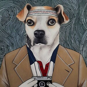 May include: A white dog with brown ears wearing a brown jacket and a white headband with red and blue stripes. The dog is holding a silver camera in front of its chest. The background is a dark green with white swirls.