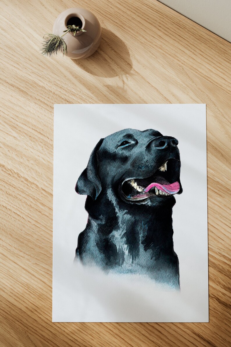 May include: A watercolor painting of a black Labrador Retriever with its mouth open and tongue sticking out. The dog is looking up and to the right. The painting is on a white background.