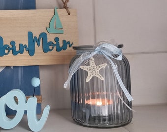 large glass lantern in light blue with bow and decorative felt star