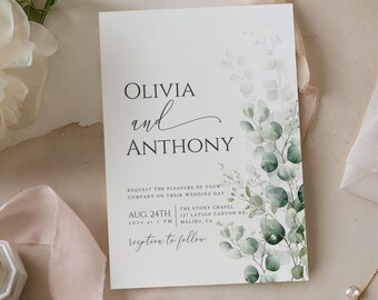 May include: A white wedding invitation card featuring the names Olivia and Anthony in black serif and script fonts, with a watercolor illustration of green eucalyptus leaves along the right side and text detailing the event date and location.
