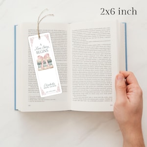 May include: A white bookmark with a pink and blue illustration of a stack of books tied with a pink ribbon. The bookmark has the text "A Love Story Begins" and "Elizabeth's Bridal Shower Jan 17th 202X". The bookmark is 2 inches by 6 inches.