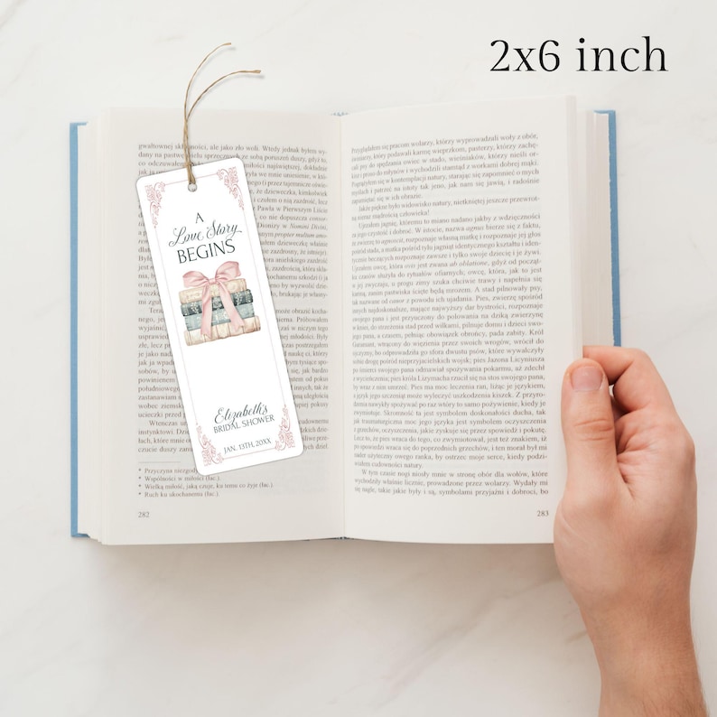 May include: A white bookmark with a pink and blue illustration of a stack of books tied with a pink ribbon. The bookmark has the text "A Love Story Begins" and "Elizabeth's Bridal Shower Jan 17th 202X". The bookmark is 2 inches by 6 inches.