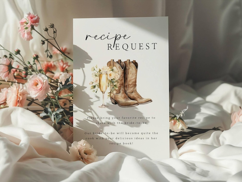 May include: A white card with the text "recipe request" in black calligraphy. The card features a watercolor illustration of a pair of brown cowboy boots with a glass of champagne and flowers.