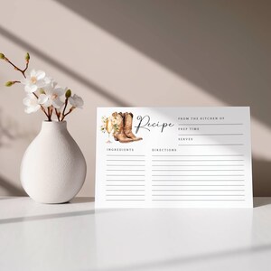 May include: A printable recipe card with a watercolor illustration of cowboy boots and a glass of champagne. The card has lines for writing the recipe title, from the kitchen of, prep time, serves, ingredients, and directions.