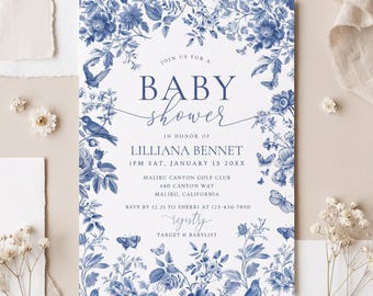 May include: A rectangular baby shower invitation card featuring a white background with a blue floral and bird border. The text reads: JOIN US FOR A BABY SHOWER IN HONOR OF LILLIANA BENNET 1PM SAT, JANUARY 13 20XX MALIBU CANYON GOLF CLUB 440 CANYON WAY MALIBU, CALIFORNIA RSVP BY 12.21 TO SHERRI AT 123-456-7890 registry TARGET & BABYLIST.