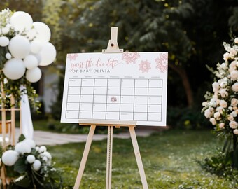 May include: A white sign on a wooden easel with the text "Guess the due date of Baby Olivia." The sign is a calendar with the words "Due Date" marked. The background includes white balloons and floral arrangements.