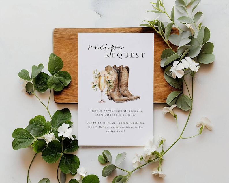 May include: A white card with the text "recipe request" in black script font. The card features a watercolor illustration of two brown cowboy boots with a glass of champagne and flowers.