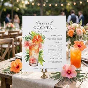 May include: A tropical cocktail bar menu on a wooden table, featuring a watercolor illustration of a cocktail with flowers. The menu lists margarita, mojito, Hawaiian blue, and piña colada. Orange hibiscus flowers and cocktails decorate the table.