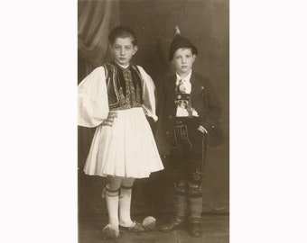 Two boys in Greek & German traditional costumes. Athens Greece 22.2.1934. Vintage photo postcard size [53058]