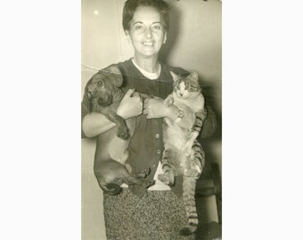 Lady with dog and cat in her arms. Greece 1950s.  Vintage photo [51671]