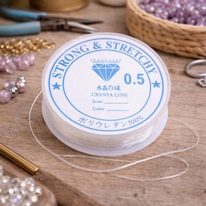 1 roll of clear elastic stretchable crystal bead string, 0.5 mm length.