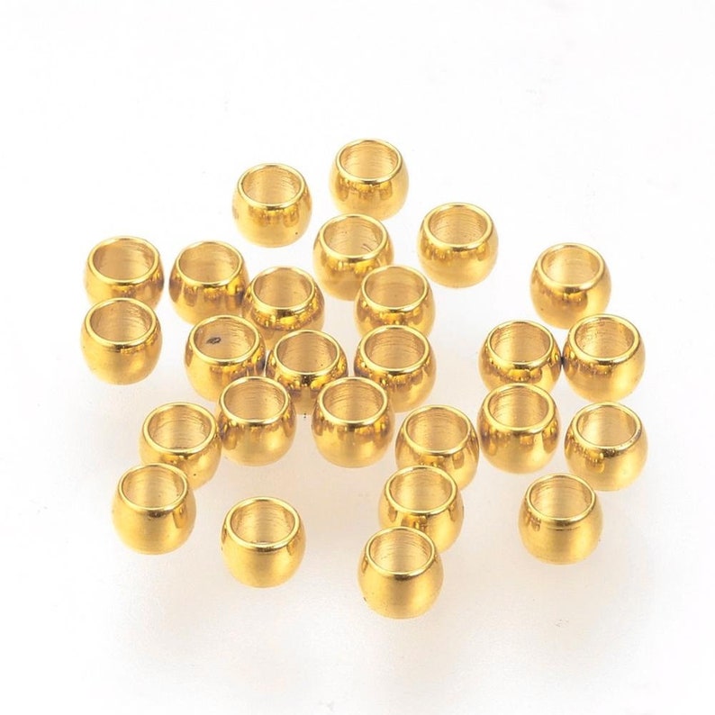 20 Edelstahl Quetschperlen goldfarben 2 x 1 mm Bild 1