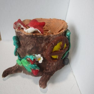 Miniature tree stump made of paper clay, decor for a roombox, for dollhouse. A forest fairy-tale stump-house, empty inside. Mushroom, snail
