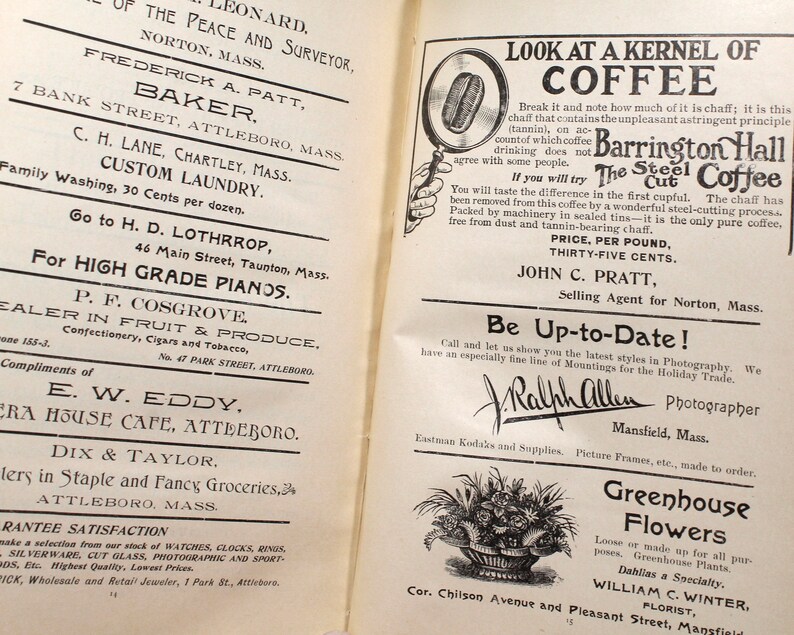 May include: An open book page with vintage advertisements. Text includes business names, services, and product descriptions. The page is aged with a yellowed tone, featuring various fonts and illustrations.