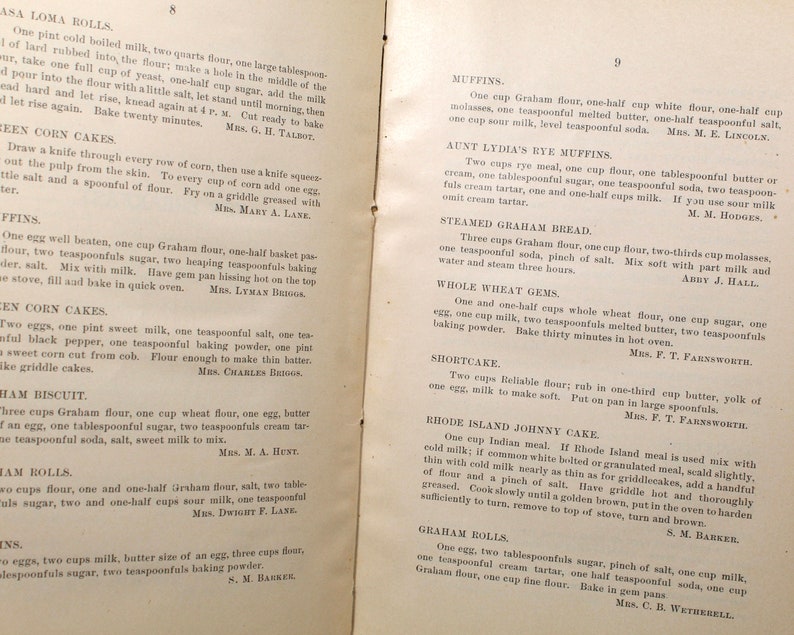 May include: Open book pages with handwritten recipes for various baked goods, including muffins, corn cakes, and rolls. The text is in black ink on aged paper, with some recipes attributed to specific individuals.