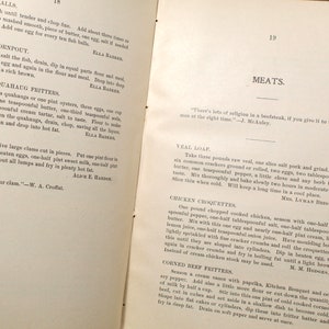 May include: Open book pages with vintage recipes for fish balls, oyster fritters, and veal loaf. The text is in black ink on aged paper, with headings like "MEATS" and author attributions.