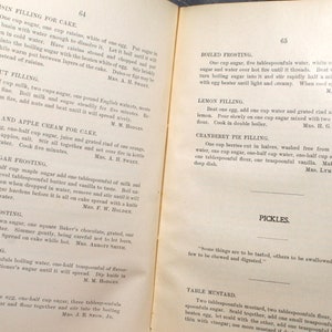 May include: A vintage cookbook page featuring recipes for cake fillings and frostings, including raisin, walnut, orange, and maple sugar variations. The page also includes a recipe for pickles and table mustard.