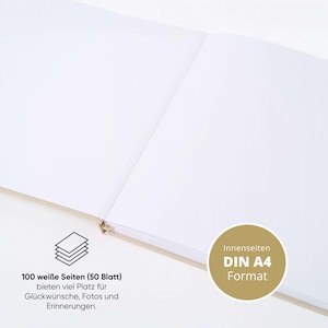 May include: An open, blank notebook with white pages. The notebook has a light-colored spine and binding. Text on the image reads "100 white pages (50 sheets) offer plenty of space for wishes, photos and memories" and "DIN A4 Format."