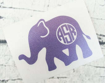 May include: Purple glitter elephant silhouette with a white circle monogram in the center that says "ASR".
